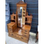 A VICTORIAN WALNUT STEPPED DRESSING TABLE, THE BASE ENCLOSING CUPBOARD AND FOUR DRAWERS WITH THE