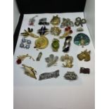 A COLLECTION OF TWENTY FOUR GOOD QUALITY COSTUME BROOCHES AND BADGES