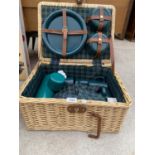 A WICKER PICNIC HAMPER CONTAINING A PICNIC SET