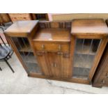 AN EARLY 20TH CENTURY OAK GLAZED AND LEADED SIDE-BY-SIDE CABINET, 48" WIDE