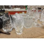 AN AMOUNT OF CUT GLASS INCLUDING SWEET JAR, JUGS, CANDLE HOLDERS, PRESERVE POTS, ETC, SOME ENGRAVED