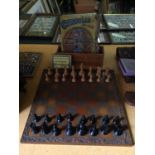 A WOODEN CARVED CHESSBOARD COMPLETE WITH THE PIECES PLUS DRAUGHTS AND A VINTAGE JIGSAW