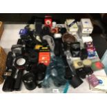 A LARGE COLLECTION OF CAMERA EQUIPMENT TO INCLUDE LENSES, LENS COVERS, FLASHES, LIGHT METER, FILM
