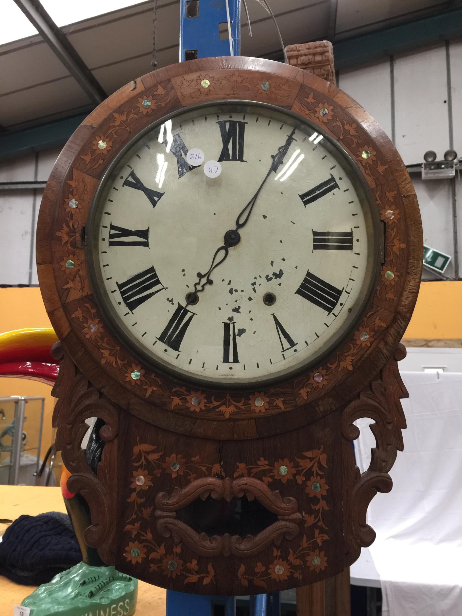 A DECORATIVE WALL CLOCK WITH ROMAN NUMERALS AND MOTHER OF PEARL INLAY