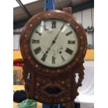 A DECORATIVE WALL CLOCK WITH ROMAN NUMERALS AND MOTHER OF PEARL INLAY