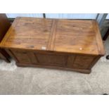 AN OAK ANTIQUE STYLE LOW TABLE/CHEST WITH PULL-OUT TOP SECTION REVEALING PARTITIONED STORAGE AND TWO