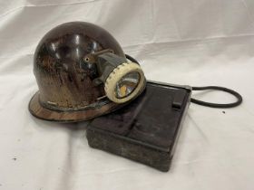 AN OLDHAM AND SONS MINERS LIGHT WITH BATTERY ON A HELMET