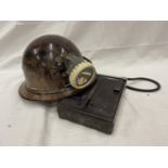 AN OLDHAM AND SONS MINERS LIGHT WITH BATTERY ON A HELMET