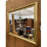 A LARGE GILT FRAMED WALL MIRROR