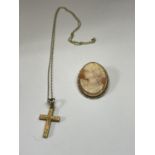 A 9 CARAT GOLD CHAIN WITH A YELLOW METAL CROSS AND A CAMEO WITH A TESTED TO 9 CARAT GOLD SURROUND