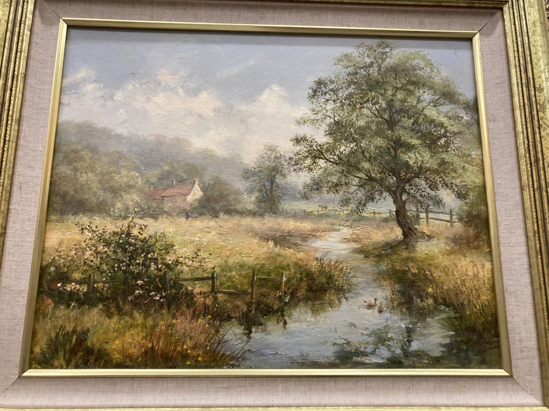 A FRAMED OIL ON CANVAS DEPICTING A PICTURESQUE SCENE OF A DISTANT HOUSE SET IN AN IDEALLIC RURAL - Image 2 of 4