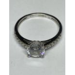 A 9 CARAT WHITE GOLD RING WITH A CENTRE CUBIC ZIRCONIA AND SMALLER ONES TO THE SHOULDERS SIZE I