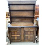 A REPRODUCTION OAK DRESSER COMPLETE WITH PLATE RACK, 48" WIDE