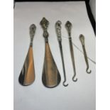 FIVE SILVER HANDLED ITEMS TO INCLUDE BUTTON HOOKS AND SHOE HORNS