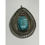 A LARGE SILVER TEAR DROP SHAPED PENDANT WITH A TURQUOISE STONE