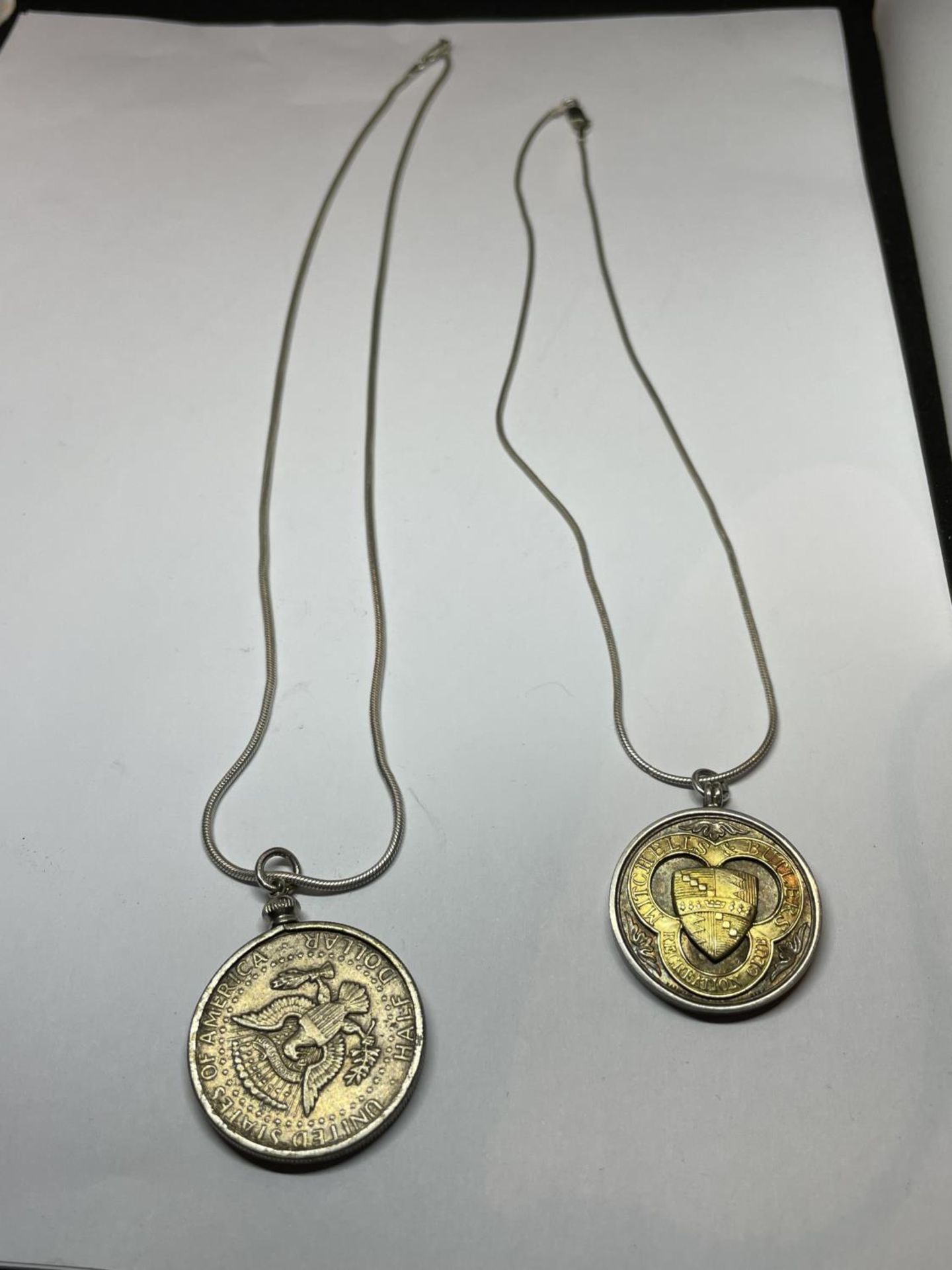 TWO MARKED SILVER CHAINS WITH PENDANTS TO INCLUDE A 1964 HALF DOLLAR AND A FURTHER MEDAL