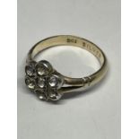 A MARKED 9 CARAT GOLD AND SILVER RING WITH SEVEN CLEAR STONES DEPICTING A FLOWER DESIGN SIZE K IN