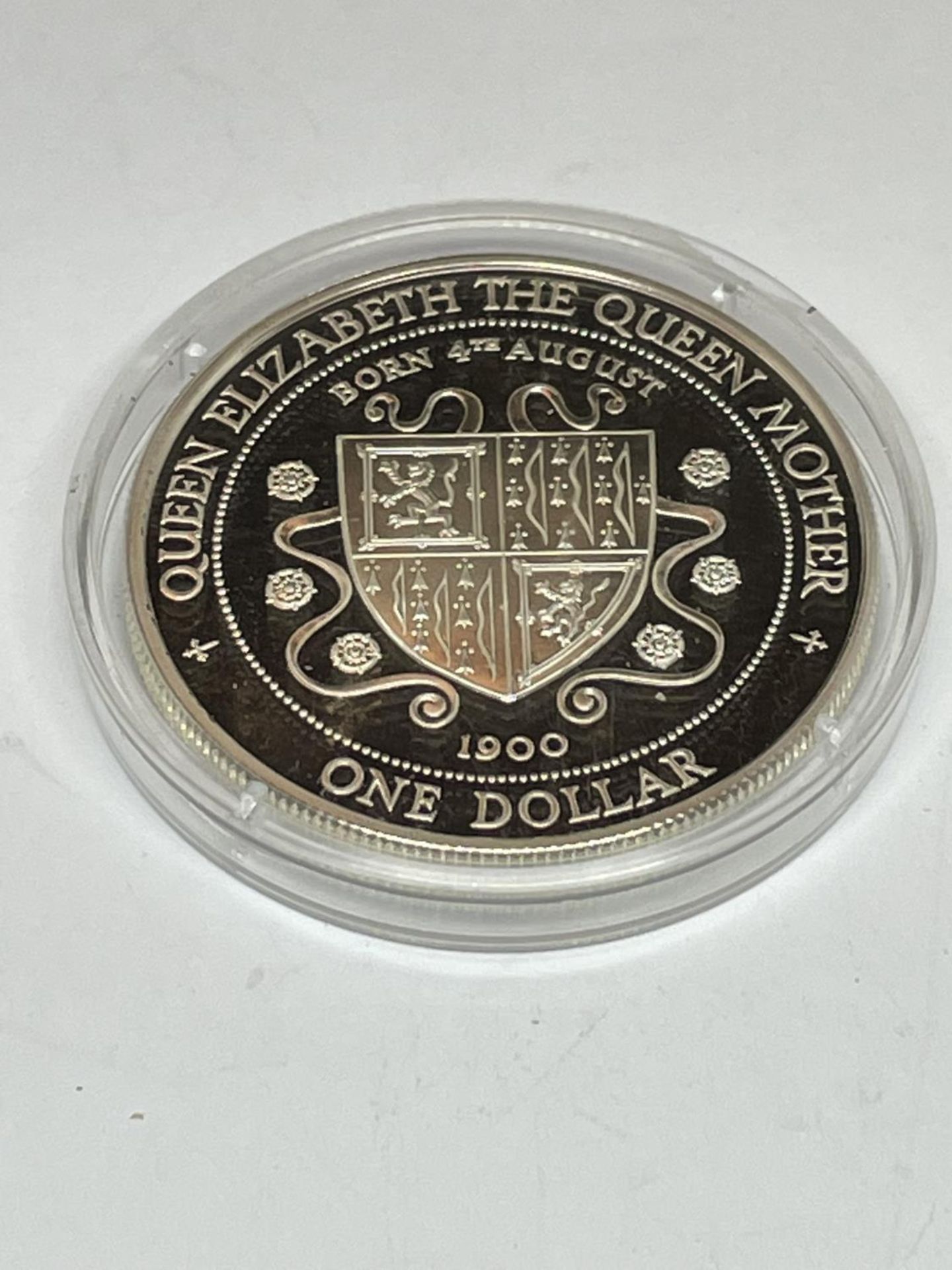 A SILVER PROOF ONE DOLLAR COIN IN A CAPSULE