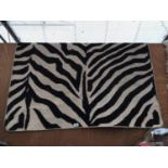 A MODERN ZEBRA PATTERNED RUG