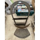 A SMALL CAST IRON FIRE PLACE WITH GRATE AND FIRE FRONT