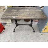 A SQUARE PUB TABLE WITH CAST IRON BASE