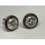 A PAIR OF WHITE GOLD POSSIBLY PLATINUM DIAMOND AND RUBY EARRINGS. EACH DIAMOND IS APPROXIMATELY 1.