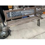 A WOODEN SLATTED GARDEN BENCH WITH CAST IRON BENCH ENDS AND A PLASTIC BACK