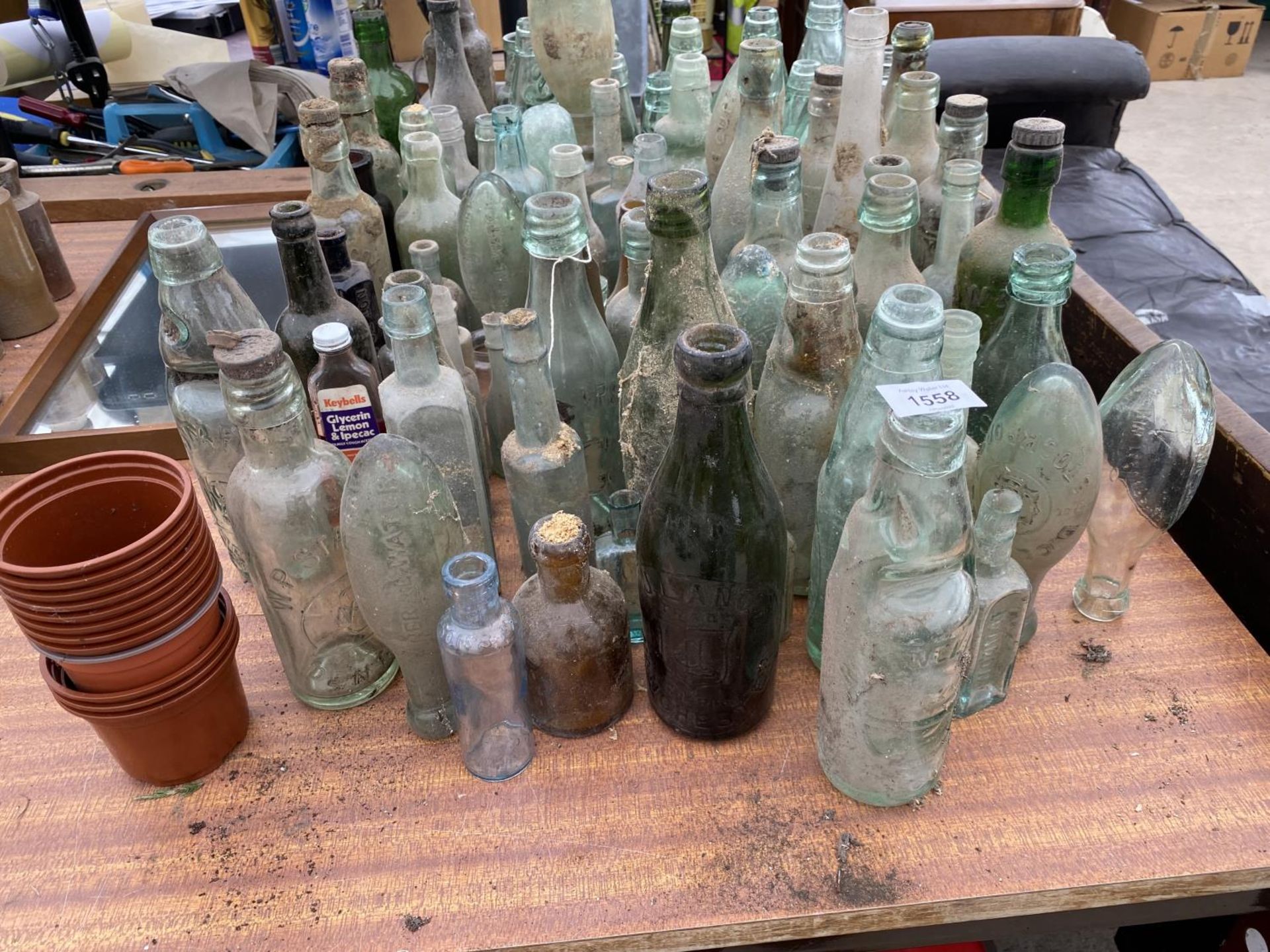 A LARGE QUANTITY OF VINTAGE GLASS BOTTLES SOME BEARING NAMES - Image 2 of 3