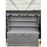 A GREY PAINTED PINE DRESSER COMPLETE WITH PLATE RACK, THE BASE ENCLOSING FOUR DRAWERS AND FOUR