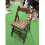A VINTAGE WOODEN FOLDABLE CHAIR