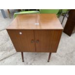 A RETRO TEAK TWO DOOR RECORD CABINET, 20" WIDE