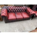 AN OXBLOOD CHESTERFIELD THREE SEATER SETTEE