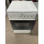 A WHITE INDESIT GAS AND ELECTRIC OVEN AND HOB