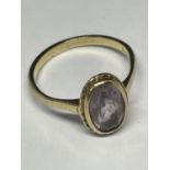 A 9 CARAT GOLD RING WITH A CENTRAL PALE PURPLE STONE SIZE N/O GROSS WEIGHT 2.5 GRAMS