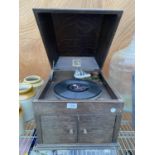 A VINTAGE WOODEN CASED HIS MASTERS VOICE WIND UP GRAMAPHONE WITH HANDLE AND CLEANING PAD