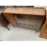 A RETRO TEAK BOOKCASE WITH FIXED DOOR AND TWO GLASS SLIDING DOORS, 42" WIDE