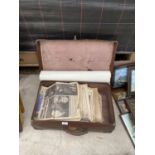 A VINTAGE TRAVEL CASE WITH A QUANTITY OF NEWSPAPERS