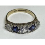 A 9 CARAT GOLD RING WITH TWO SAPPHIRES AND THREE CLEAR STONES IN A BAND SIZE L/M