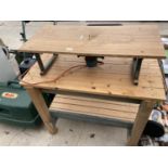 A WOODEN WORK BENCH AND A ROUTER TABLE COMPLETE WITH ROUTER