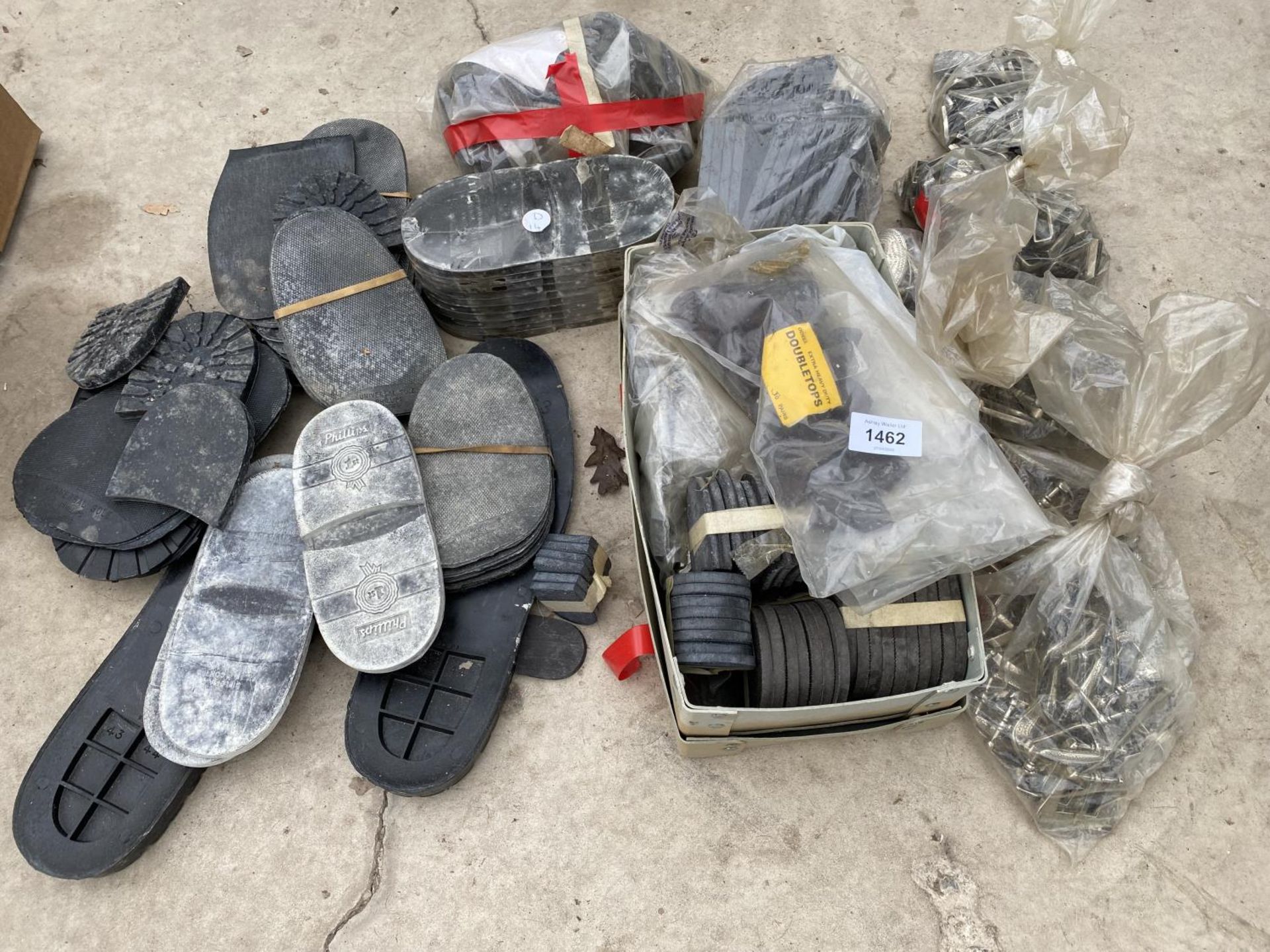 A LARGE ASSORTMENT OF SHOE SOLES AND BELT BUCKLES