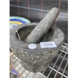 A LARGE STONE PESTLE AND MORTAR