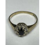 A 9 CARAT GOLD RING WITH A CENTRAL SAPPHIRE SURROUNDED BY DIAMONDS SIZE N
