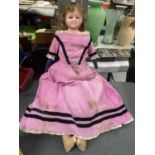 A VINTAGE CHILD'S DOLL WITH A STRAW FILLED CLOTH BODY, PLASTIC HEAD -A/F, AND PERIOD DRESS