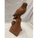 A TERRACOTTA STONE ROOF FINIAL OF A HAWK