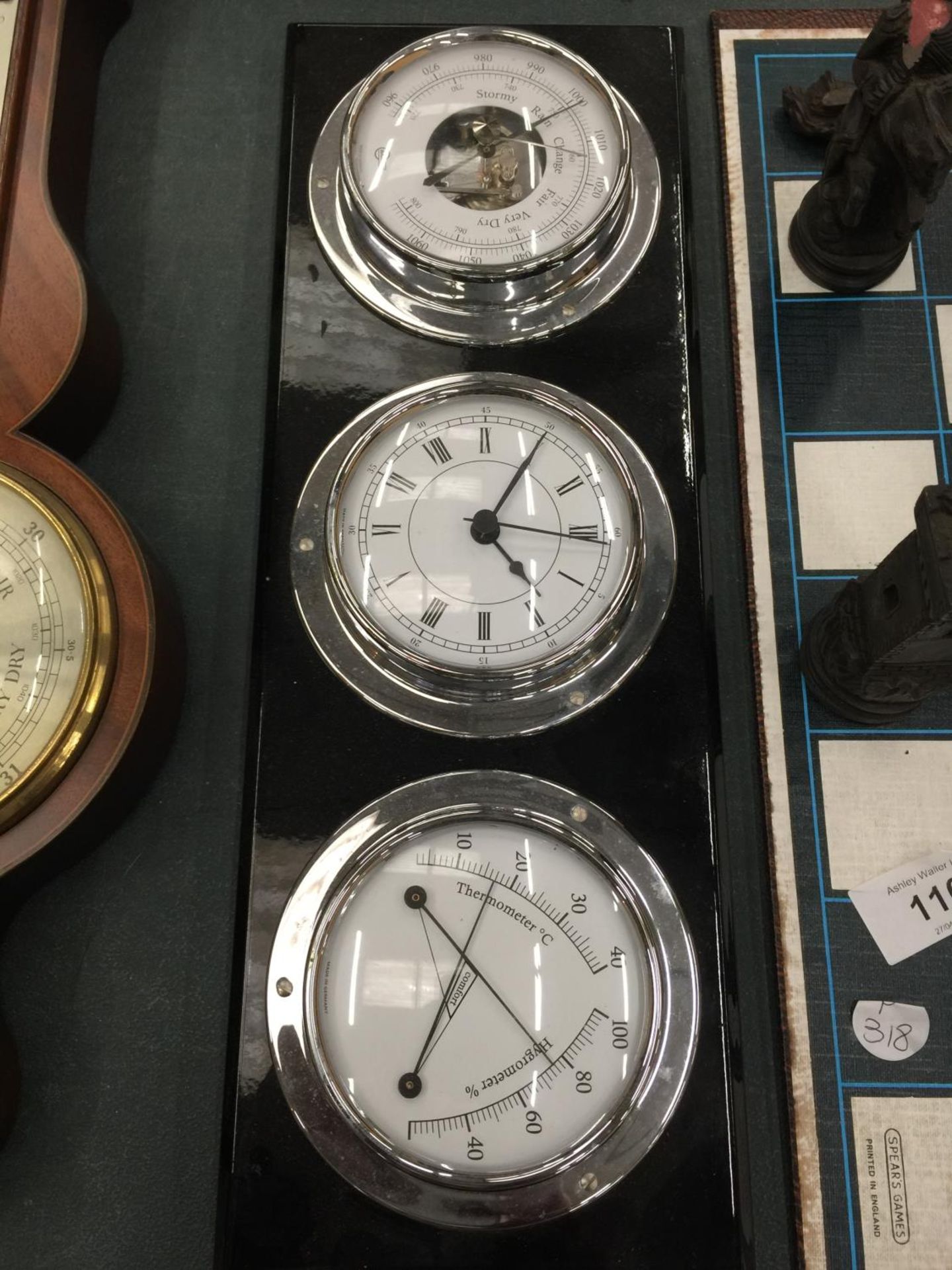 A WALL HANGING SET OF THREE BAROMETER, CLOCK AND THERMOMETER/HYGROMETER 37CM X 13CM