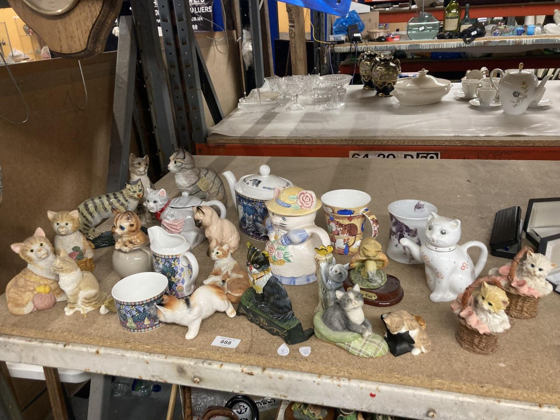 A COLLECTION OF RESIN AND POTTERY CAT RELATED ITEMS TO INCLUDE TEAPOTS, ORNAMENTS, DOORSTOP, MUGS,