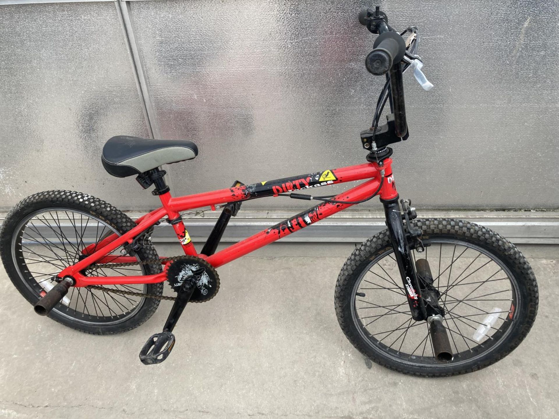A DIRTY BMX BIKE WITH FRONT AND REAR STUNT PEGS