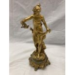 A GILT SPELTER FIGURE OF A LADY WITH A BIRD PRISONNIERE ON AN ONYX BASE
