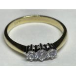 A 9 CARAT GOLD RING WITH THREE IN LINE CLEAR STONES SIZE N