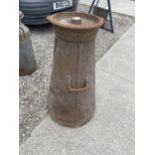 A LARGE VINTAGE CAST IRON MILK CHURN